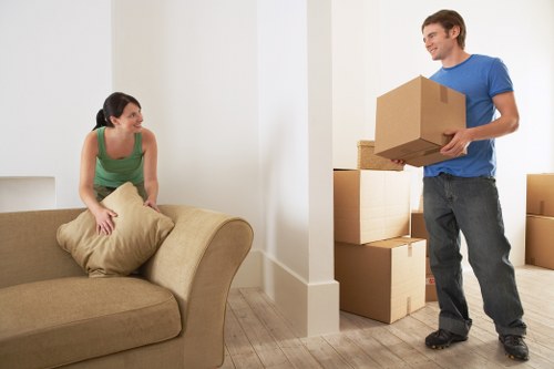 Local moving team handling boxes and furniture near Haggerston flats